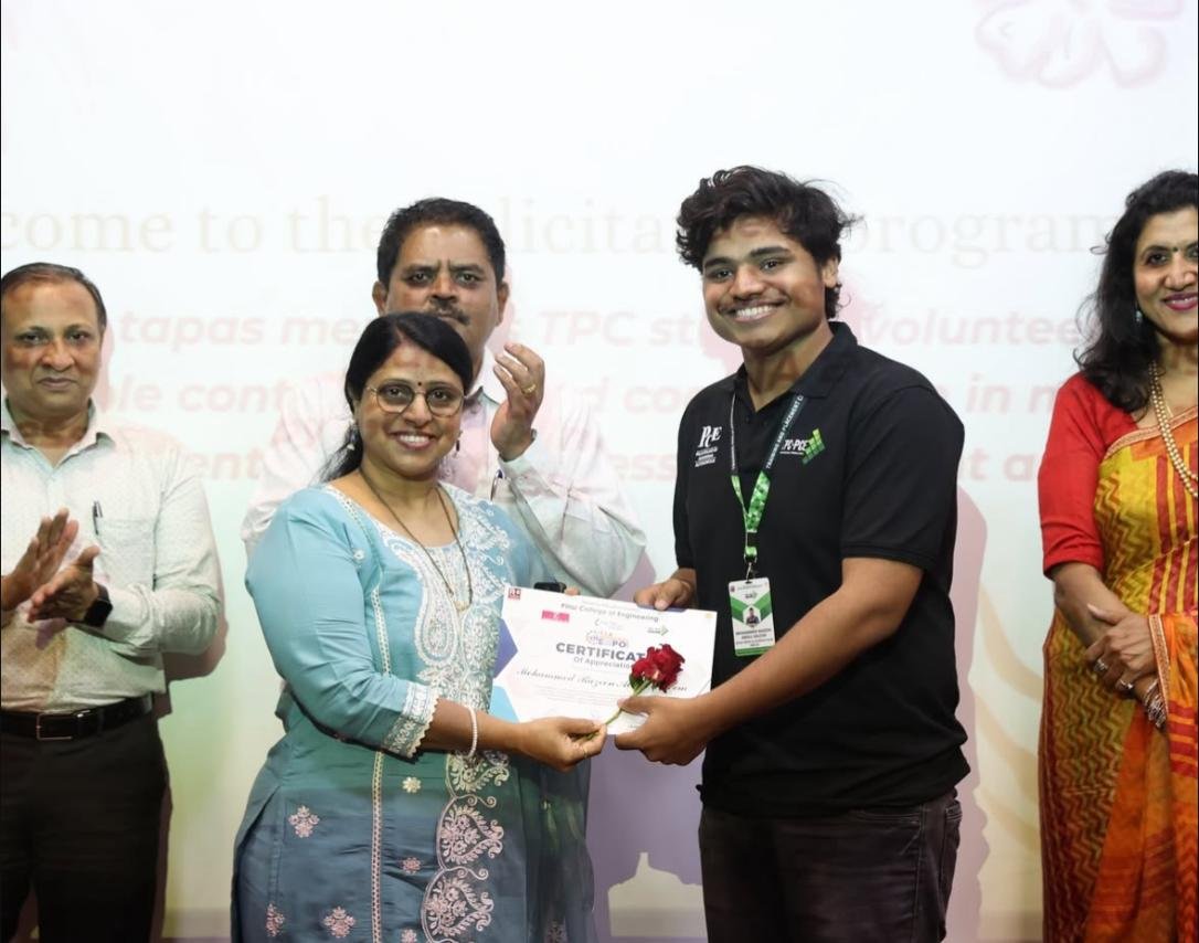 Certificate or award being presented between two people