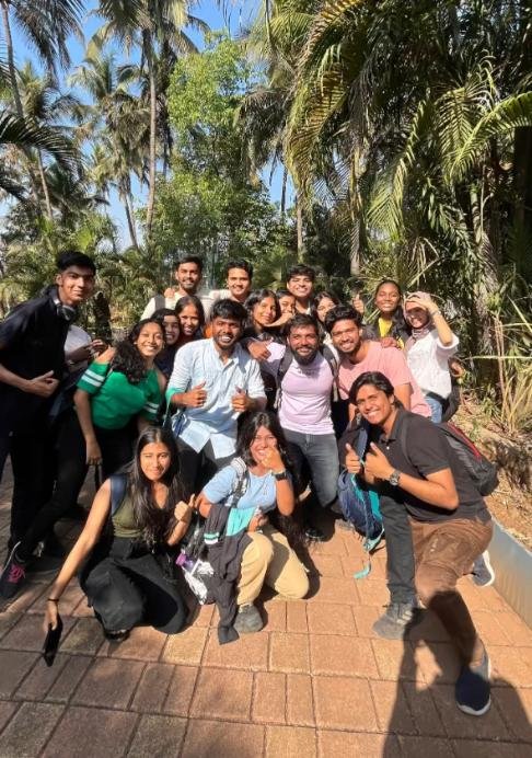Group photo outdoors among palm trees