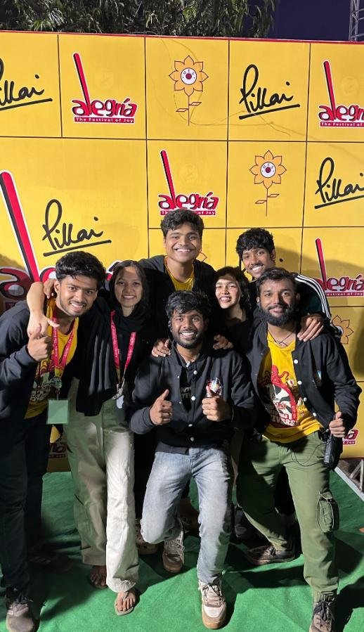 Group photo at an event in front of a branded backdrop