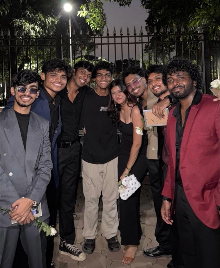 Friends dressed up and posing together at night