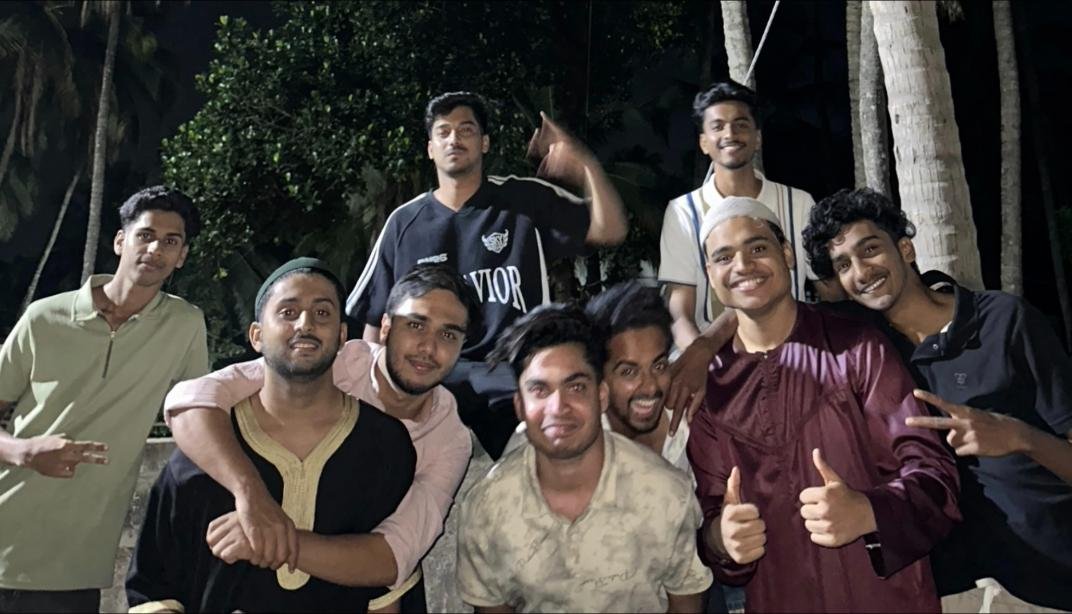 Group of friends posing together outdoors at night