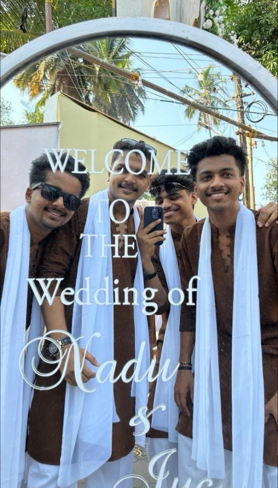 Wedding welcome sign framed by a floral arch